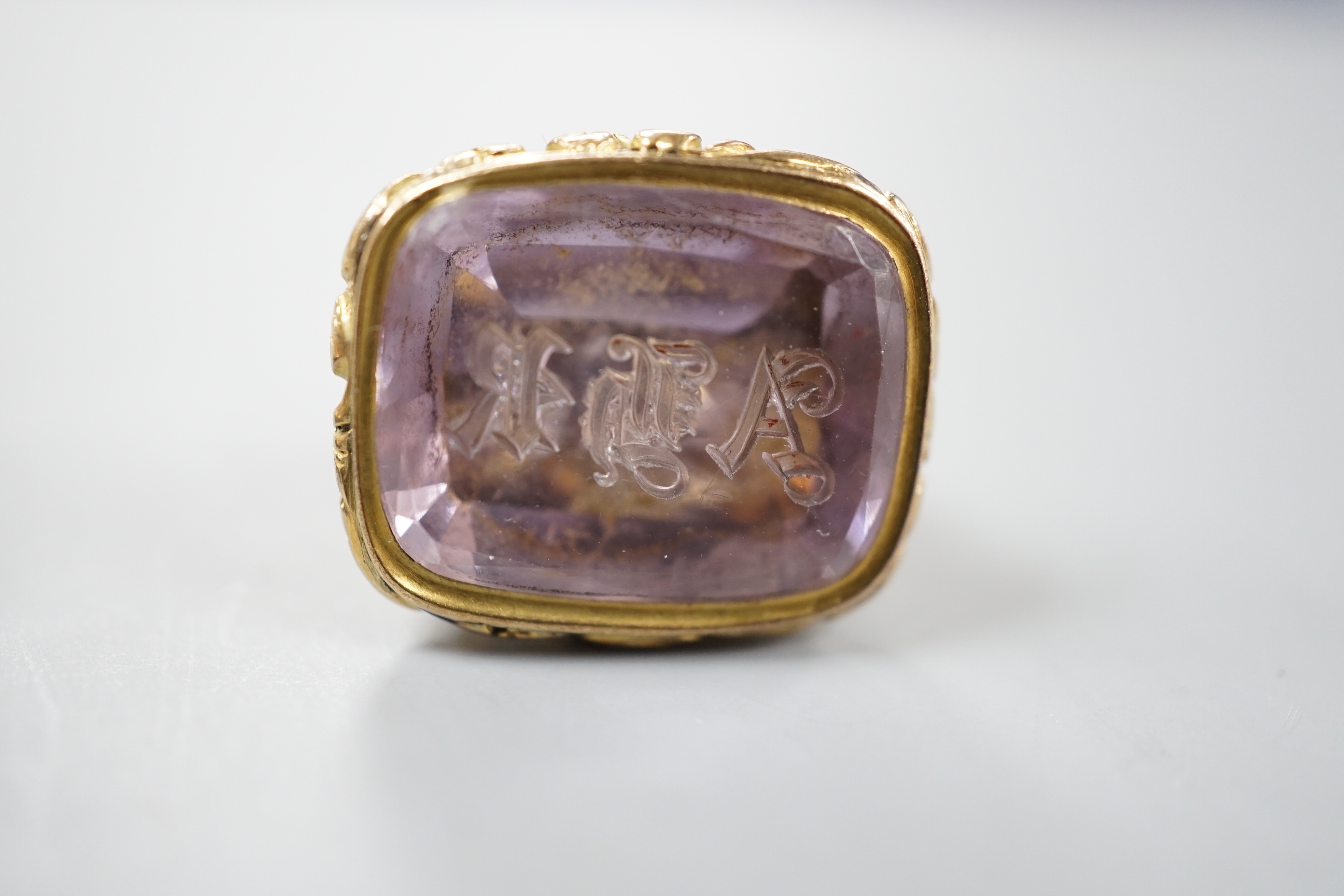 A 19th century yellow metal overlaid and foil backed gem set fob seal, 25mm, a similar chalcedony set spinning fob and a bloodstone set yellow metal overlaid watch key.